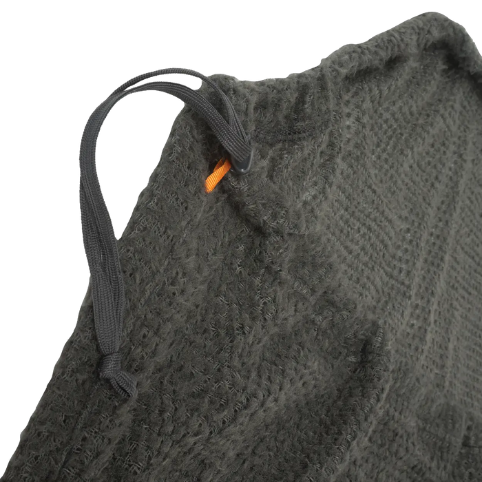 Close-up of a textured gray fabric with a black drawstring and orange tag.