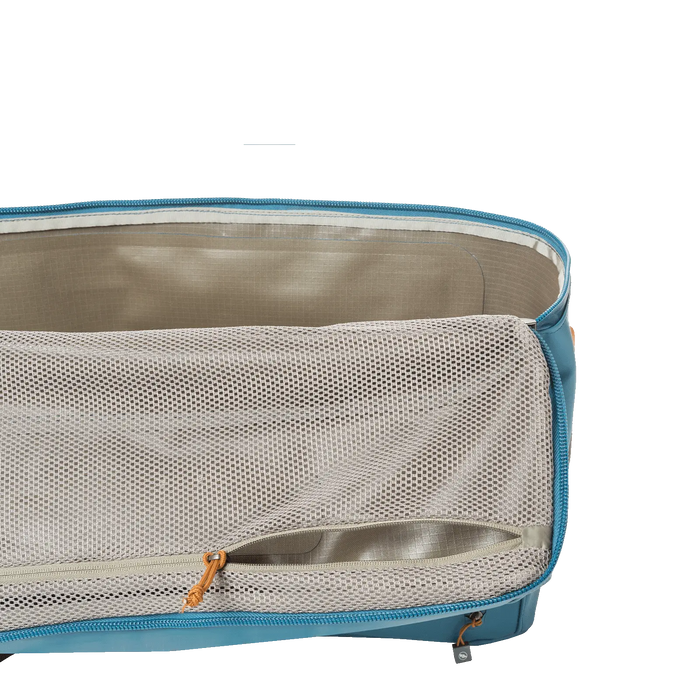 A blue packing cube with a beige mesh zippered cover, partially opened to show the interior and an extra small pocket on the flap—perfect for organizing essentials inside your Big Joe Gear Duffel by Big Agnes.