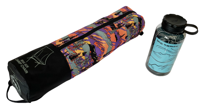 A vibrant zippered bag labeled Big Six Camp Chair - Alpenglow by Big Agnes sits beside a clear water bottle, highlighting this packable chair’s easy portability for any adventure.