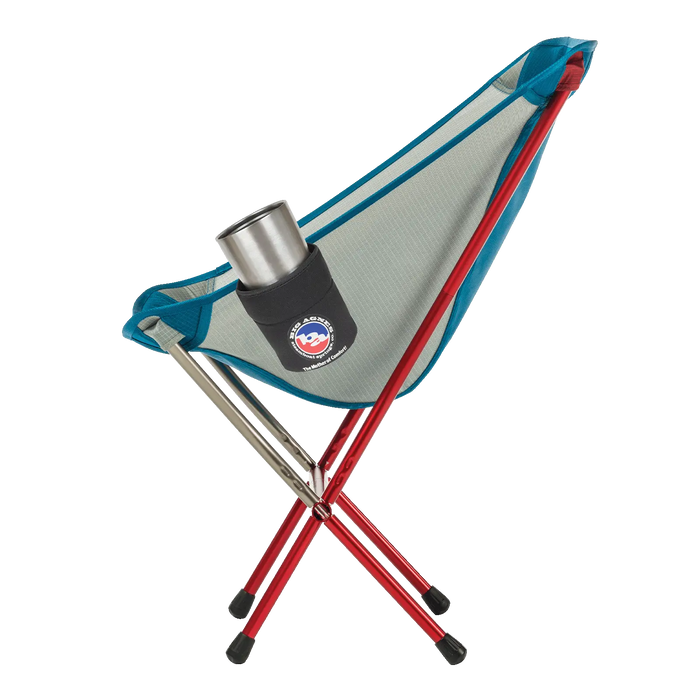 A Big Agnes Camp Chair Drink Holder features red metal legs, blue-trimmed mesh seat, and a cup holder holding a stainless steel tumbler. The lightweight chair is showcased against a white background.