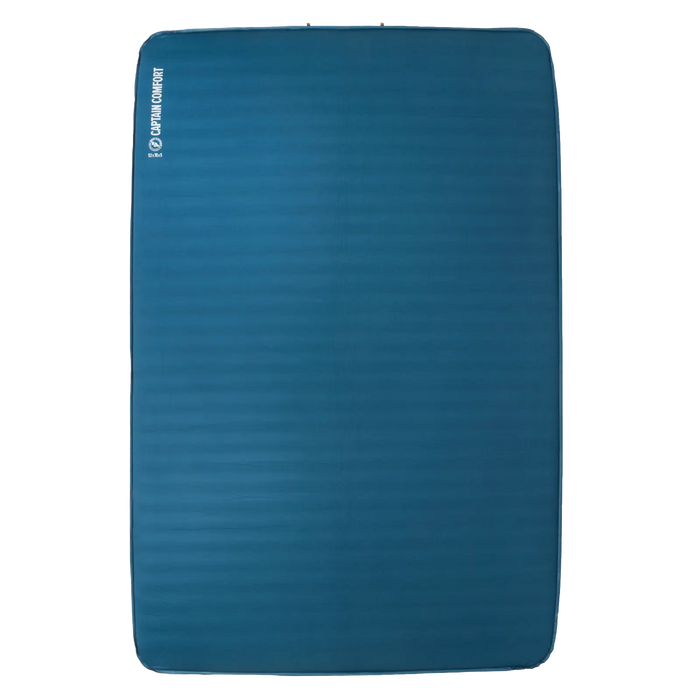 A blue rectangular self-inflating sleeping pad, the Big Agnes Captain Comfort Deluxe Camp, features slightly rounded corners, a subtle textured surface, and is shown against a white background with its logo and name in white on the upper left.