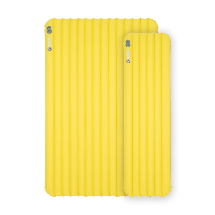 Two yellow Big Agnes Divide Insulated inflatable sleeping pads with a ribbed design are placed side by side on a white background, with one noticeably smaller than the other.