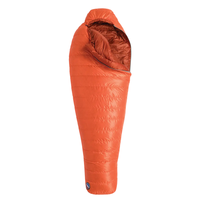 The Big Agnes Greystone 20° is an orange, mummy-style sleeping bag with a hood and DownTek insulation, designed for warm backpacking trips, shown upright against a white background.