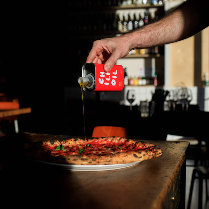olea pia - italian chili oil tin poured onto pizza - winter's moon