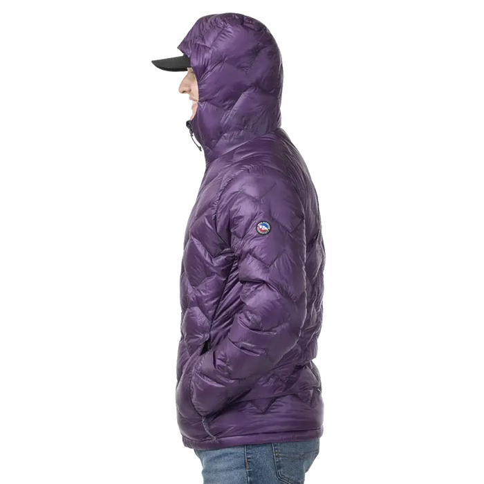 Person wearing a dark purple puffer jacket with a brand logo on a white background