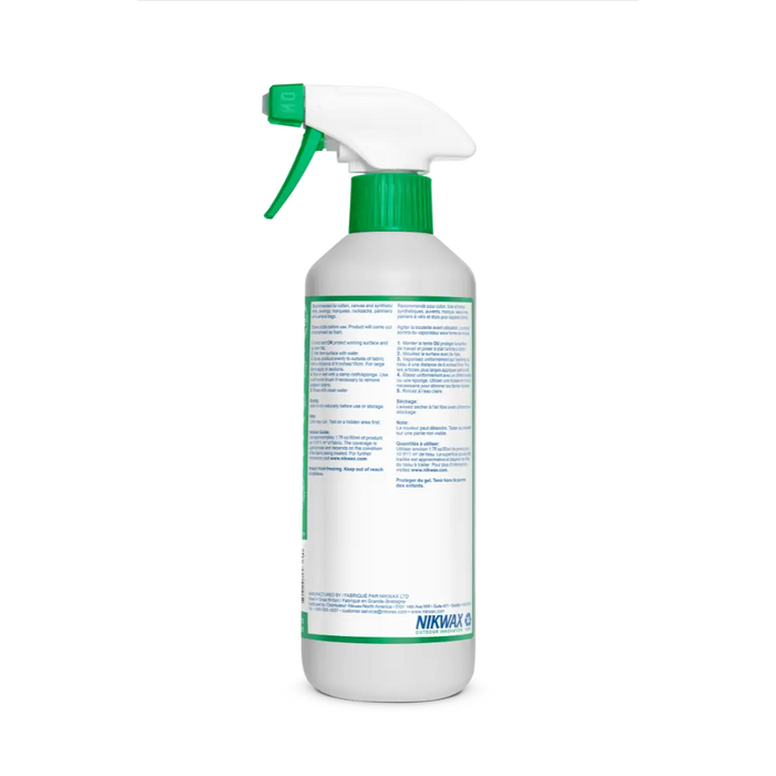 A white spray bottle with a green nozzle and cap, shown from the back. The label displays cleaning instructions for Nikwax Spray On Tent & Gear SolarWash by Big Agnes, with the brand logo visible at the bottom.
