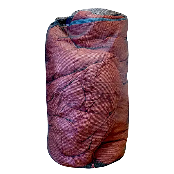 A Big Agnes Sleeping Bag Mesh Storage Sack filled with wrinkled red fabric stands upright against a plain white background.