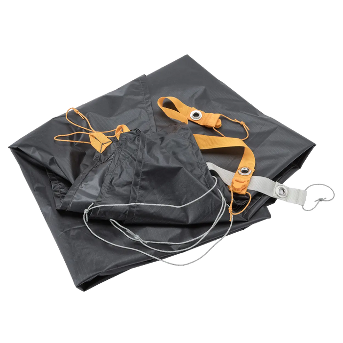 A folded Big Agnes Tiger Wall UL2 Bikepack Footprint, with orange and gray straps, metal grommets, and cords, is displayed on a white background.