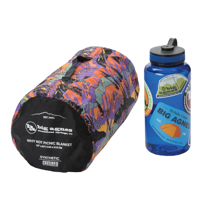 Colorful picnic blanket and blue water bottle with Big Agnes branding on a white background