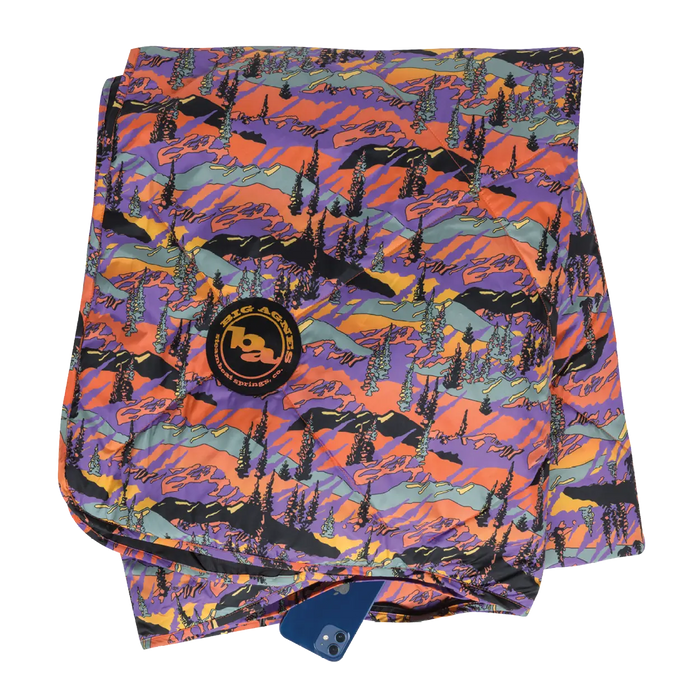 Colorful mountain-patterned towel with a brand logo on a white background