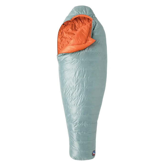 The Big Agnes Women's Greystone 30° sleeping bag features a light blue mummy-style design with 650 fill DownTek insulation and a bright orange interior, shown upright and partially unzipped.
