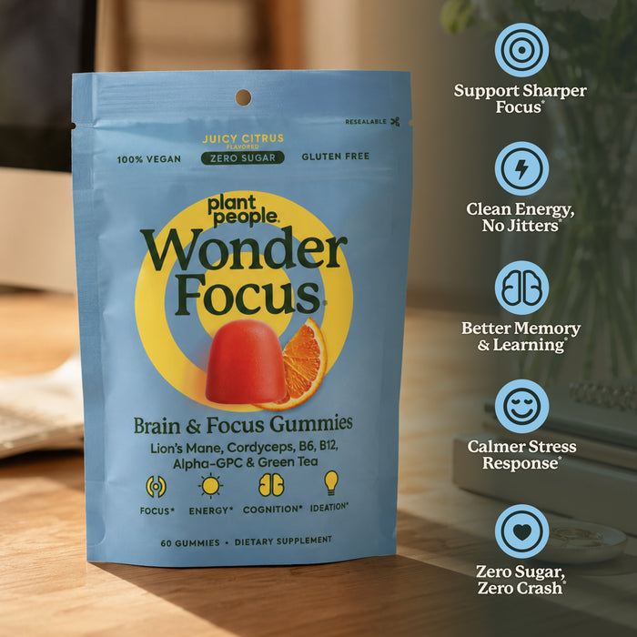 Plant People Wonder Focus Brain & Focus Gummies in a light blue stand-up pouch, shown on a wooden surface with a blurred indoor background and a vertical list of benefits on the right.