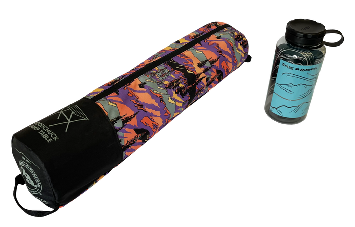 A colorful, patterned carrying case with Big Agnes branding lies next to a clear water bottle with a blue mountain design and black lid—both perfect companions for your Woodchuck Camp Table - Alpenglow adventures.