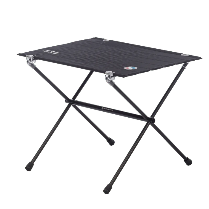 The Big Agnes Woodchuck Camp Table is a lightweight, black folding table with crossed metal legs and a fabric top—perfect for camping or picnics.